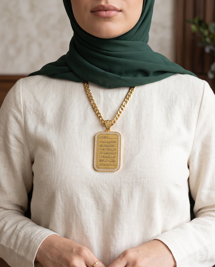 Rhinestone crowned Quran medallion necklace worn with a hijab